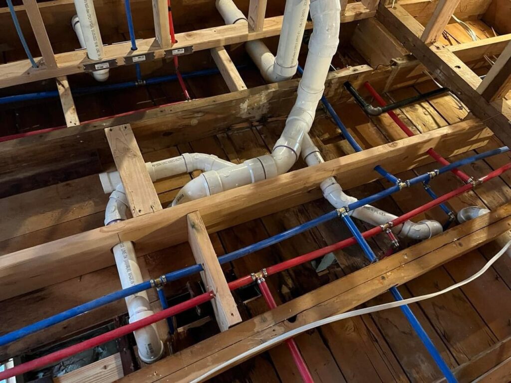 Plumber repairing slab leak beneath residential foundation
