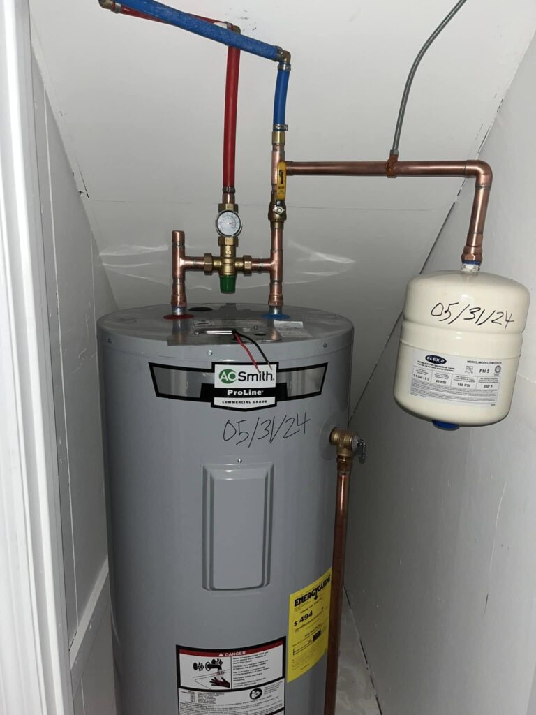 Plumber repairing broken water heater drain valve