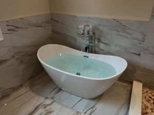 Plumber installing bathtub drain stopper mechanism