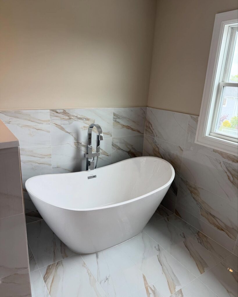 Plumber connecting bathtub drain assembly underneath tub