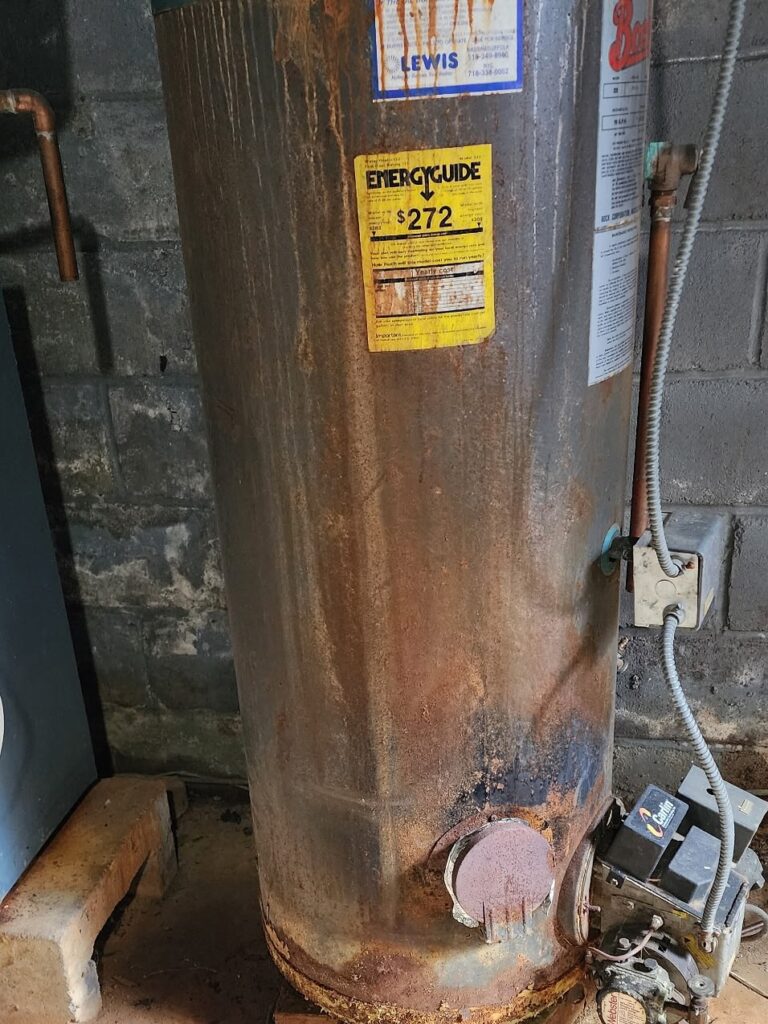 Plumber installing new residential water heater in Long Island basement