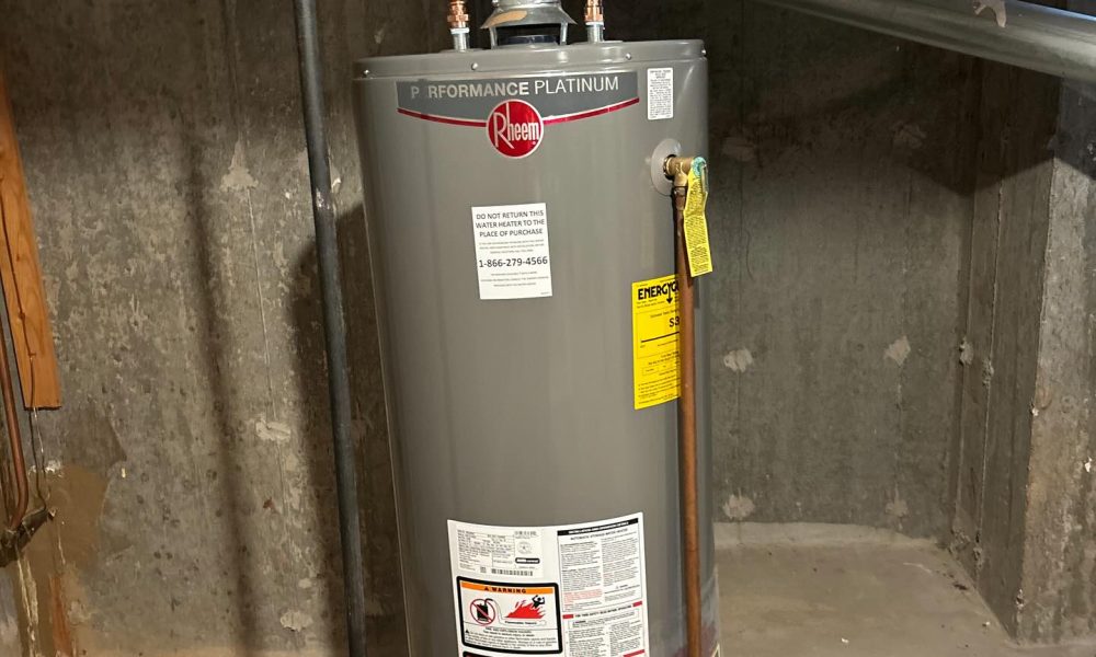 Technician installing tankless water heater in Long Island home