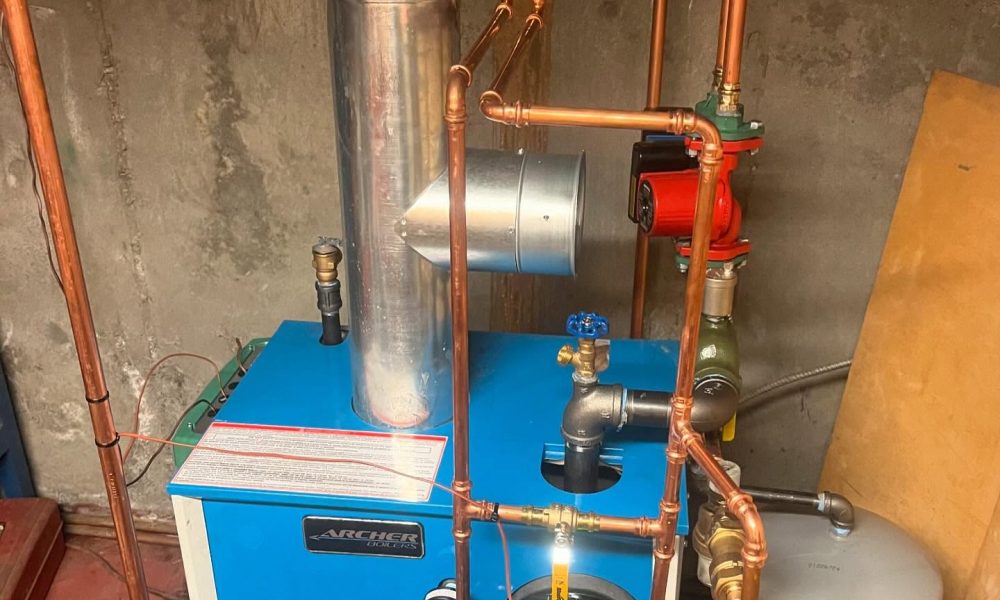 Heating technician repairing gas furnace ignition system