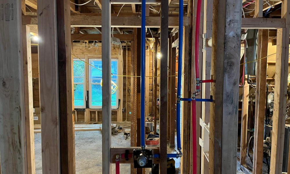 Copper hot water pipe installed inside bathroom wall