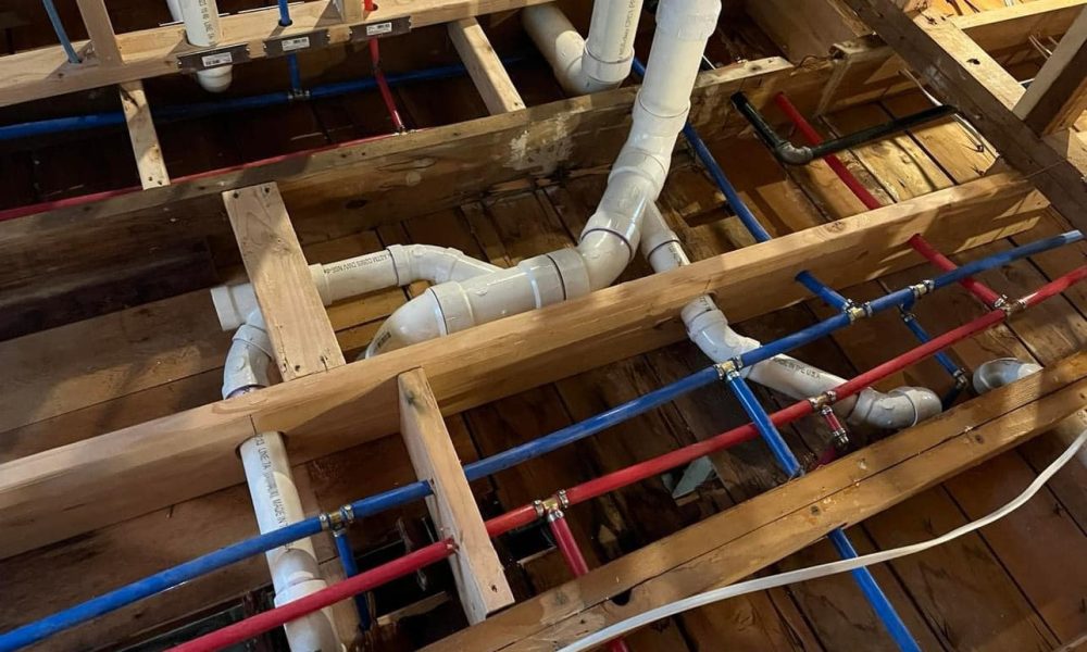 Plumber repairing slab leak beneath residential foundation