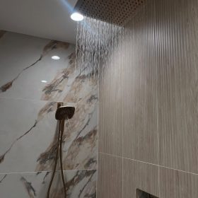 Plumber installing new shower valve in bathroom renovation