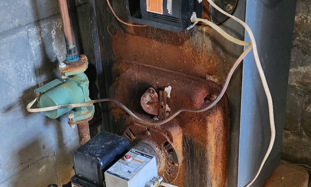 HVAC technician repairing blower motor in residential furnace