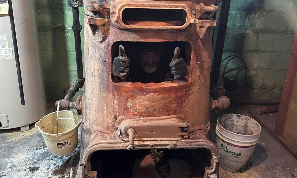 Heating technician replacing worn furnace blower belt