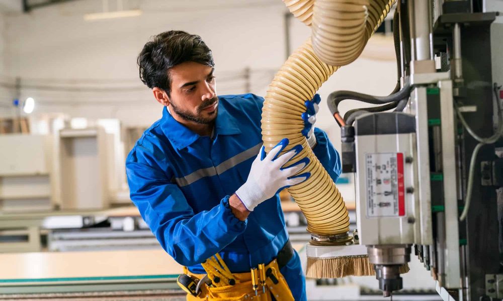 HVAC technician inspecting evaporator coil inside air handler